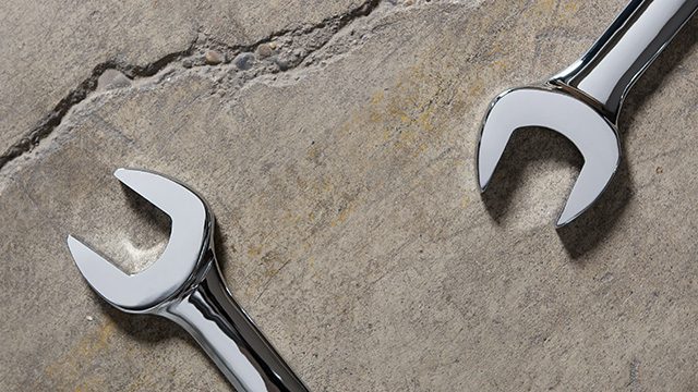 Two metal wrenches on concrete floor